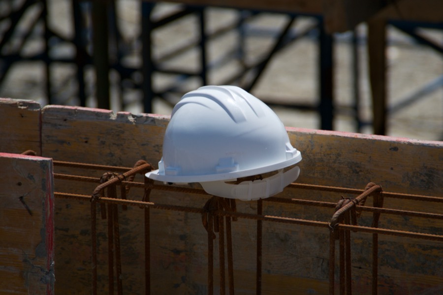 Hard hat resting on formwork at a construction site