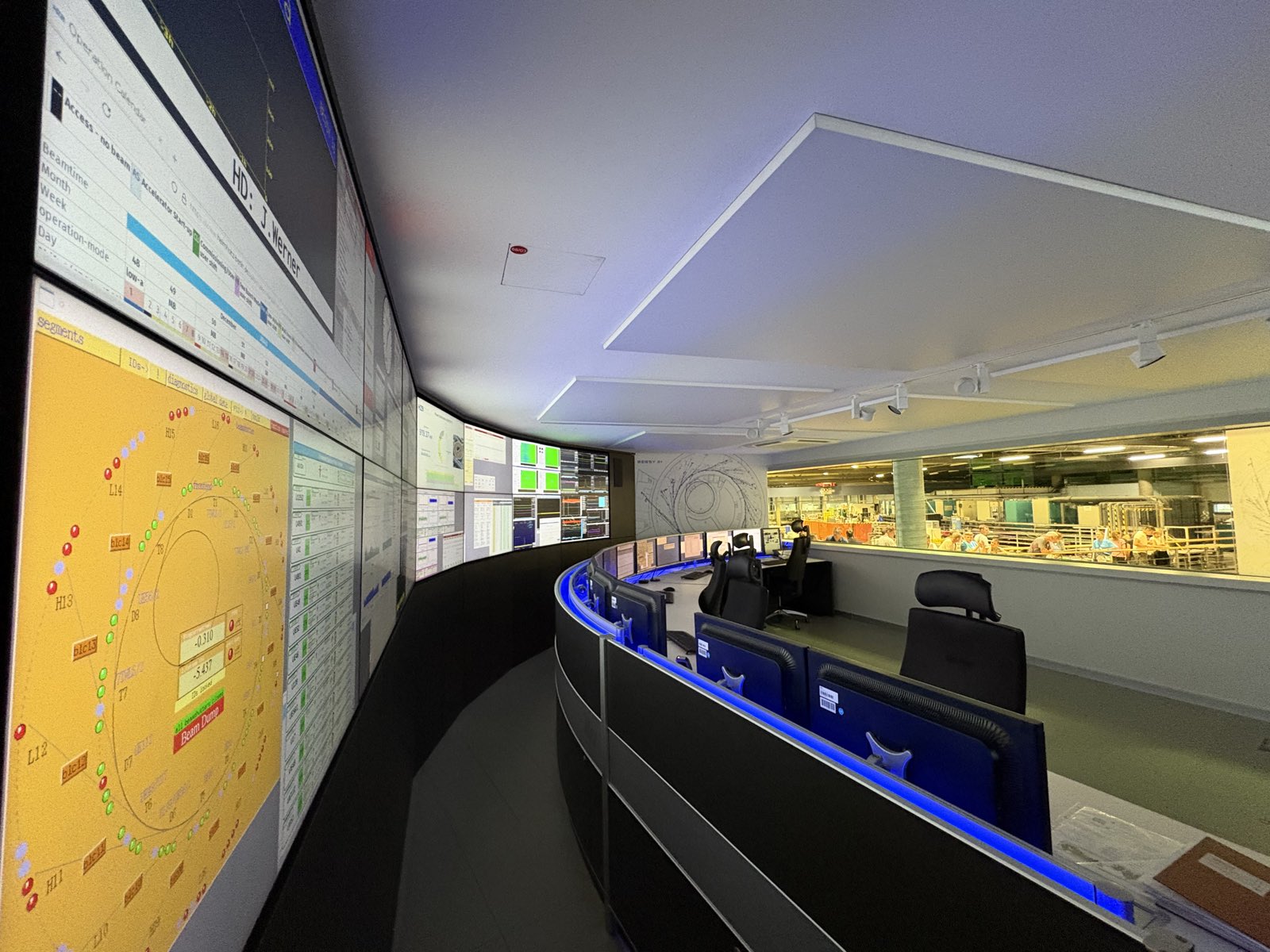 Modern operations control room with a wall of live monitoring screens
